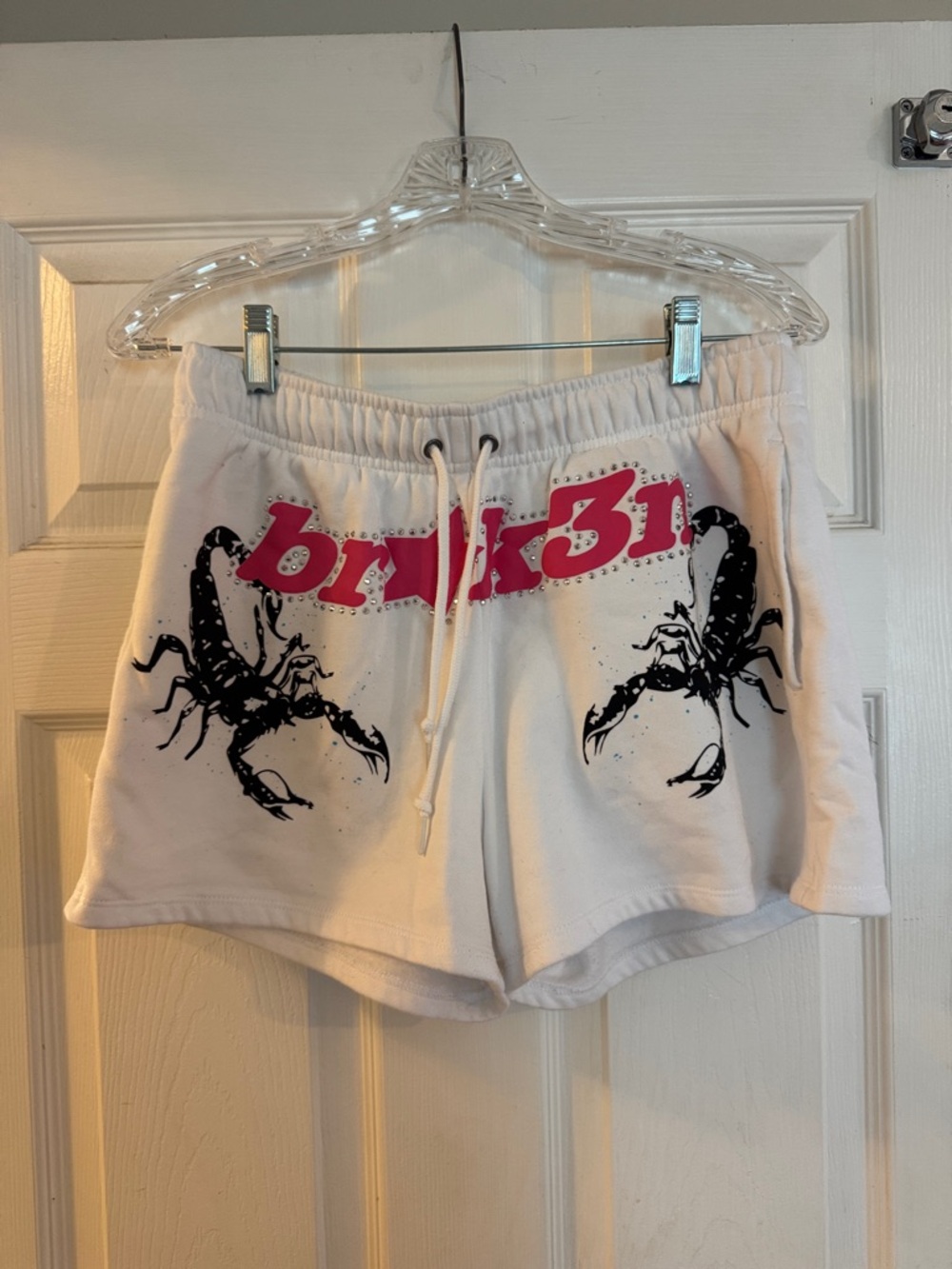 White Athletic Shorts with Pink Logo and Black Scorpion Graphic